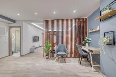 an office lobby with a wooden partition with a table and chairs at The Garden of Eden Apartment in Piraeus