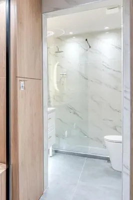 a bathroom with a glass shower and a toilet at The Garden of Eden Apartment in Piraeus