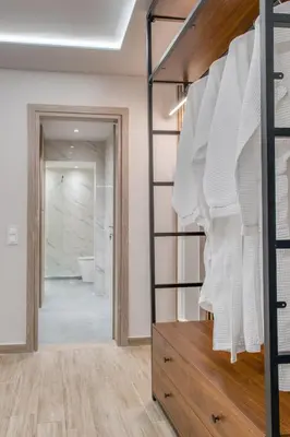 a room with a closet with white towels at The Garden of Eden Apartment in Piraeus