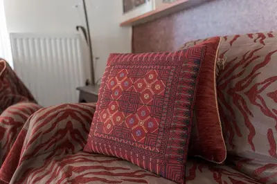 a pillow sitting on top of a couch at Comfortable Family Apartment,3 stops to Acropolis in Athens