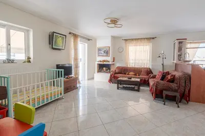 a living room with a couch and a crib at Comfortable Family Apartment,3 stops to Acropolis in Athens