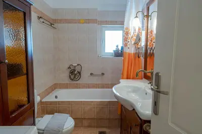 a bathroom with a tub and a toilet and a sink at Comfortable Family Apartment,3 stops to Acropolis in Athens