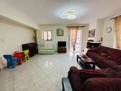 a living room with a couch and a table at Comfortable Family Apartment,3 stops to Acropolis in Athens