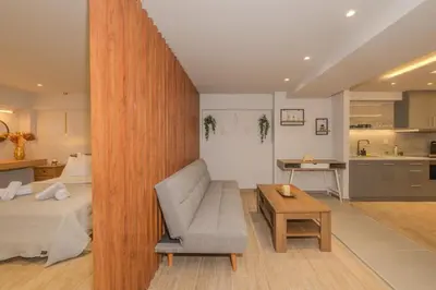 a room with a bed and a couch and a table at Pythagorio Apartment in Piraeus