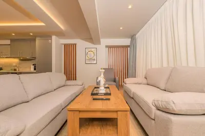 a living room with two couches and a coffee table at Pythagorio Apartment in Piraeus