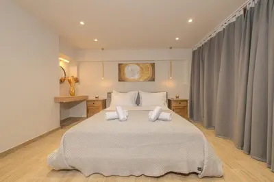 a bedroom with a large white bed with two pillows at Pythagorio Apartment in Piraeus