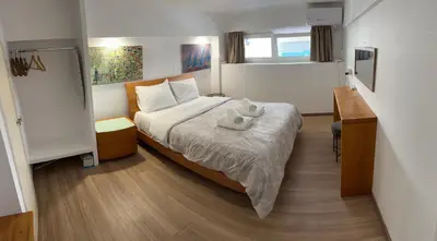 a hotel room with a bed and a desk at Ground floor next to Errikos Ntinan and Erithros in Athens