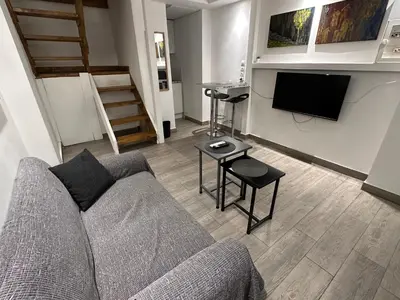 a living room with a couch and a tv at Ground floor next to Errikos Ntinan and Erithros in Athens
