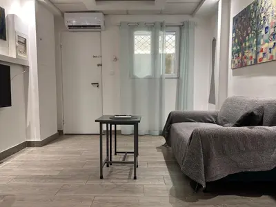 a living room with a couch and a table at Ground floor next to Errikos Ntinan and Erithros in Athens