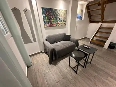 a living room with a couch and a table at Ground floor next to Errikos Ntinan and Erithros in Athens