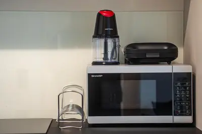 a microwave with a container on top of it at Skyline Spa Athens 110 in Athens