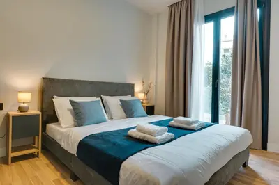 a bedroom with a large bed with towels on it at Skyline Spa Athens 110 in Athens
