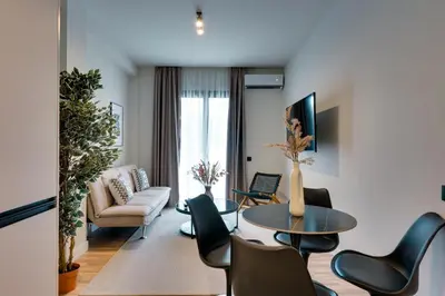 a living room with a table and chairs at Skyline Spa Athens 110 in Athens