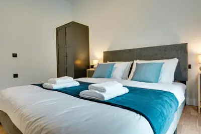 a bedroom with a large bed with towels on it at Skyline Spa Athens 110 in Athens
