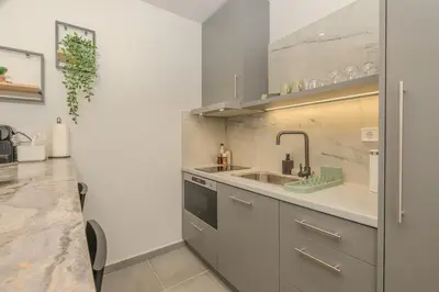 a kitchen with a sink and a counter at Pink Season Apartment in Piraeus