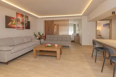 a living room with a couch and a table at Fairytale Apartment in Piraeus