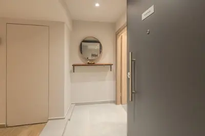 a hallway with a door and a mirror at Fairytale Apartment in Piraeus