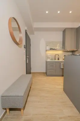 a room with a bed in the middle of a kitchen at Saint Mykonos Apartment in Piraeus