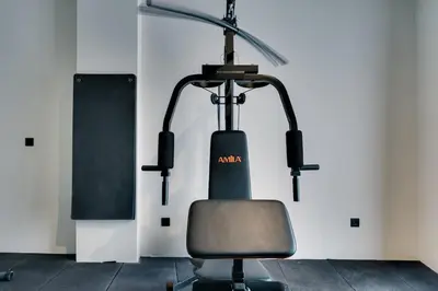 a gym with a treadmill and a chair at Skyline Spa Athens 210 in Athens