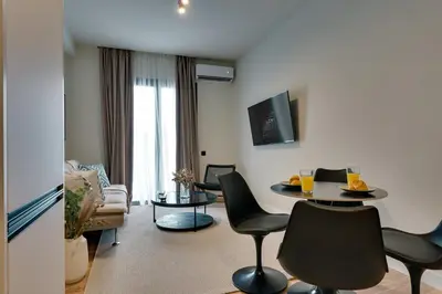 a living room with a table and chairs at Skyline Spa Athens 210 in Athens
