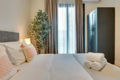 a bedroom with a large bed with towels on it at Skyline Spa Athens 210 in Athens
