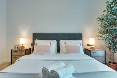 a bedroom with a large bed with towels on it at Skyline Spa Athens 210 in Athens