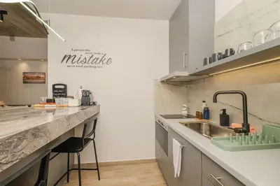 a kitchen with a sink and a counter top at Port of Crete Apartment in Piraeus