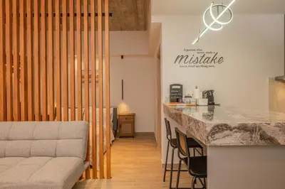 a kitchen and a living room with a couch and a counter at Port of Crete Apartment in Piraeus