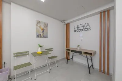 a room with chairs and a table and a desk at Port of Crete Apartment in Piraeus