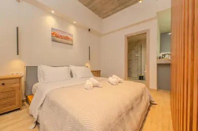 a bedroom with a large bed with towels on it at Port of Crete Apartment in Piraeus
