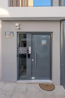 an entrance to a building with a glass door at Port of Crete Apartment in Piraeus