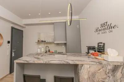 a kitchen with a large marble counter top at Dear Paris Apartment in Piraeus