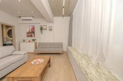 a living room with a couch and a coffee table at Dear Paris Apartment in Piraeus