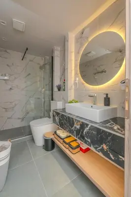 a bathroom with a sink and a toilet and a mirror at Dear Paris Apartment in Piraeus