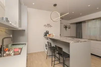 a kitchen with a counter and stools in a room at Dear Paris Apartment in Piraeus