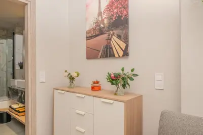 a room with a cabinet with flowers on it at Dear Paris Apartment in Piraeus