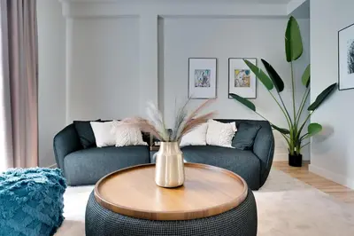a living room with a table and a couch at Skyline Spa Athens 420 - 2bd in Athens