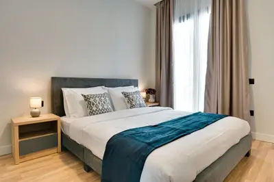 a bedroom with a large bed and a window at Skyline Spa Athens 420 - 2bd in Athens