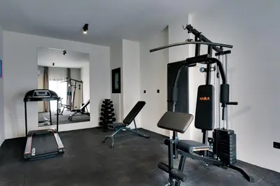 a gym with several exercise equipment in a room at Skyline Spa Athens 420 - 2bd in Athens