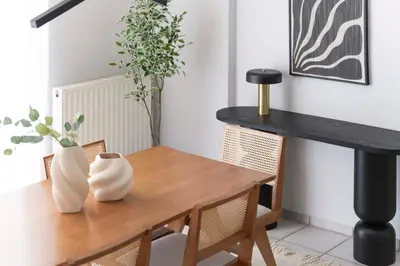 a dining room table with two vases on it at Family Escape in Chalandri by UPSTREET in Athens