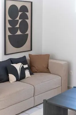 a brown couch in a living room with a picture at Family Escape in Chalandri by UPSTREET in Athens