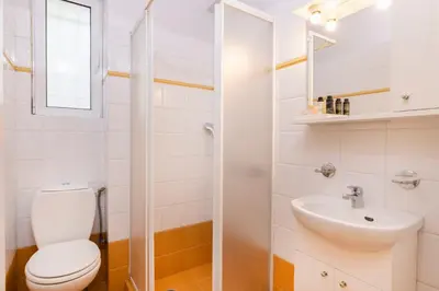 a bathroom with a toilet and a sink at Family Escape in Chalandri by UPSTREET in Athens
