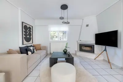 a living room with a couch and a tv at Family Escape in Chalandri by UPSTREET in Athens