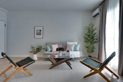a living room with a couch and a coffee table at Skyline Spa Athens 410 - 2bd in Athens