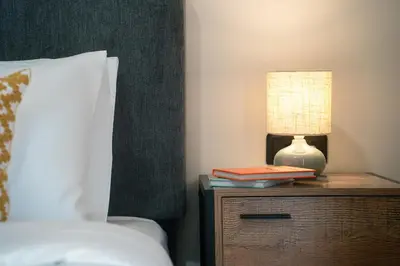 a lamp on a night stand next to a bed at Skyline Spa Athens 410 - 2bd in Athens