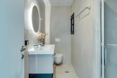 a bathroom with a sink and a toilet and a shower at Skyline Spa Athens 410 - 2bd in Athens