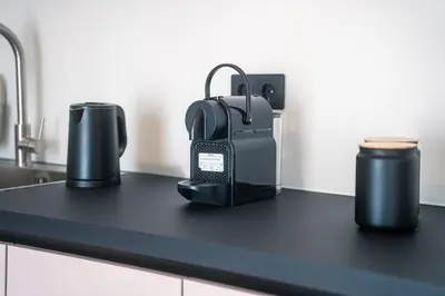 a black counter top with two cups on it at Skyline Spa Athens 410 - 2bd in Athens