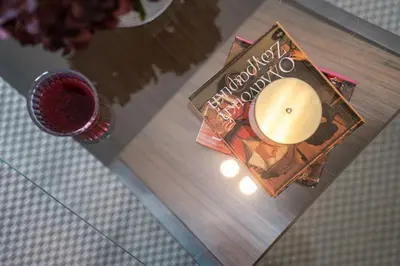 a book on a table next to a drink at Skyline Spa Athens 410 - 2bd in Athens