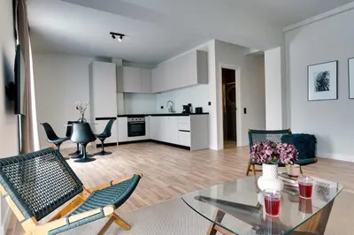 a living room with a glass table and chairs at Skyline Spa Athens 410 - 2bd in Athens