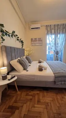 a bedroom with a large bed and a window at Luminous Apartment in Mesochórion